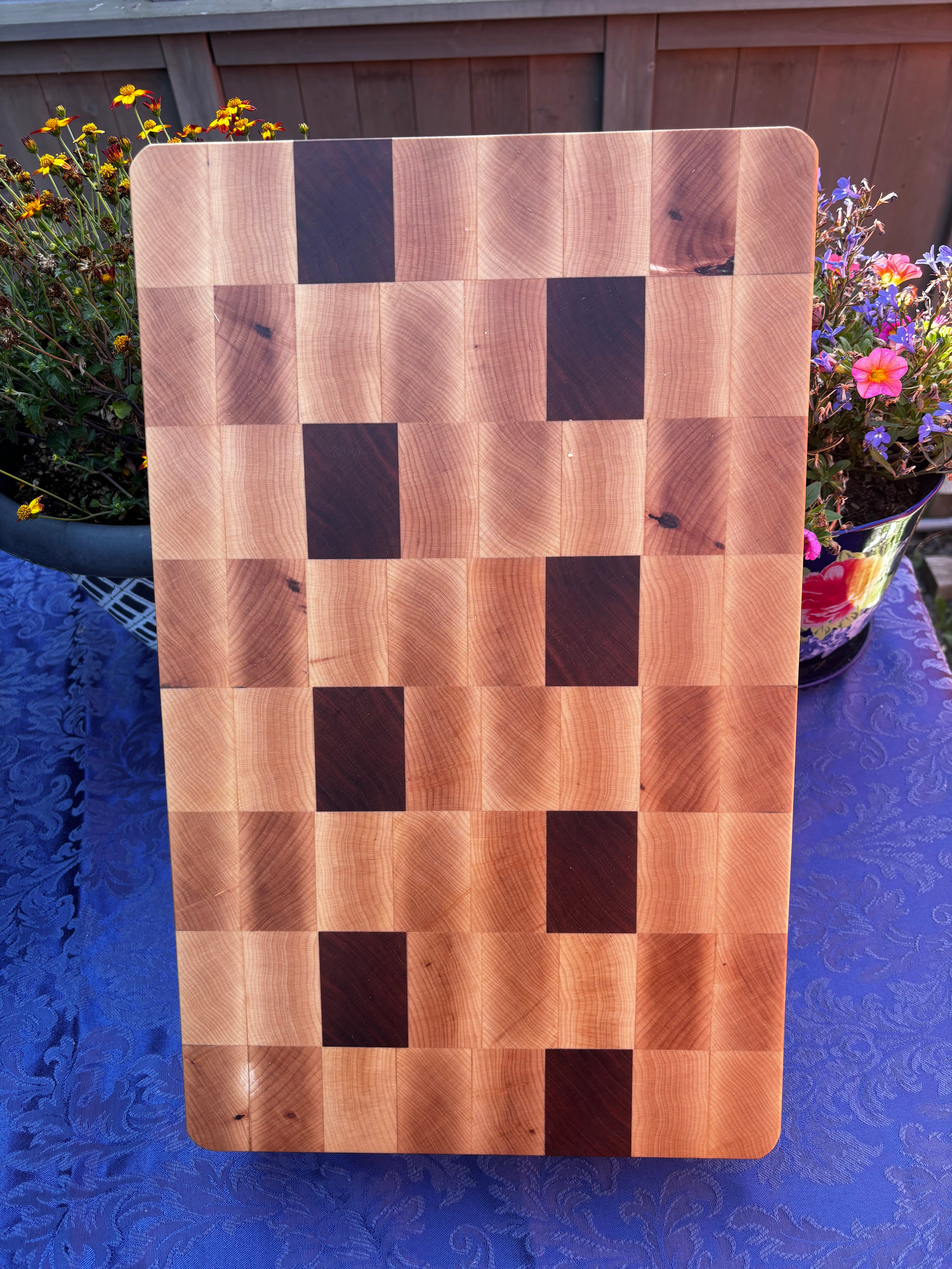 Maple and Cherry in a end grain orientation and "butcher block" style. For those that want the thickness of a butcher block without the larger size and weight.